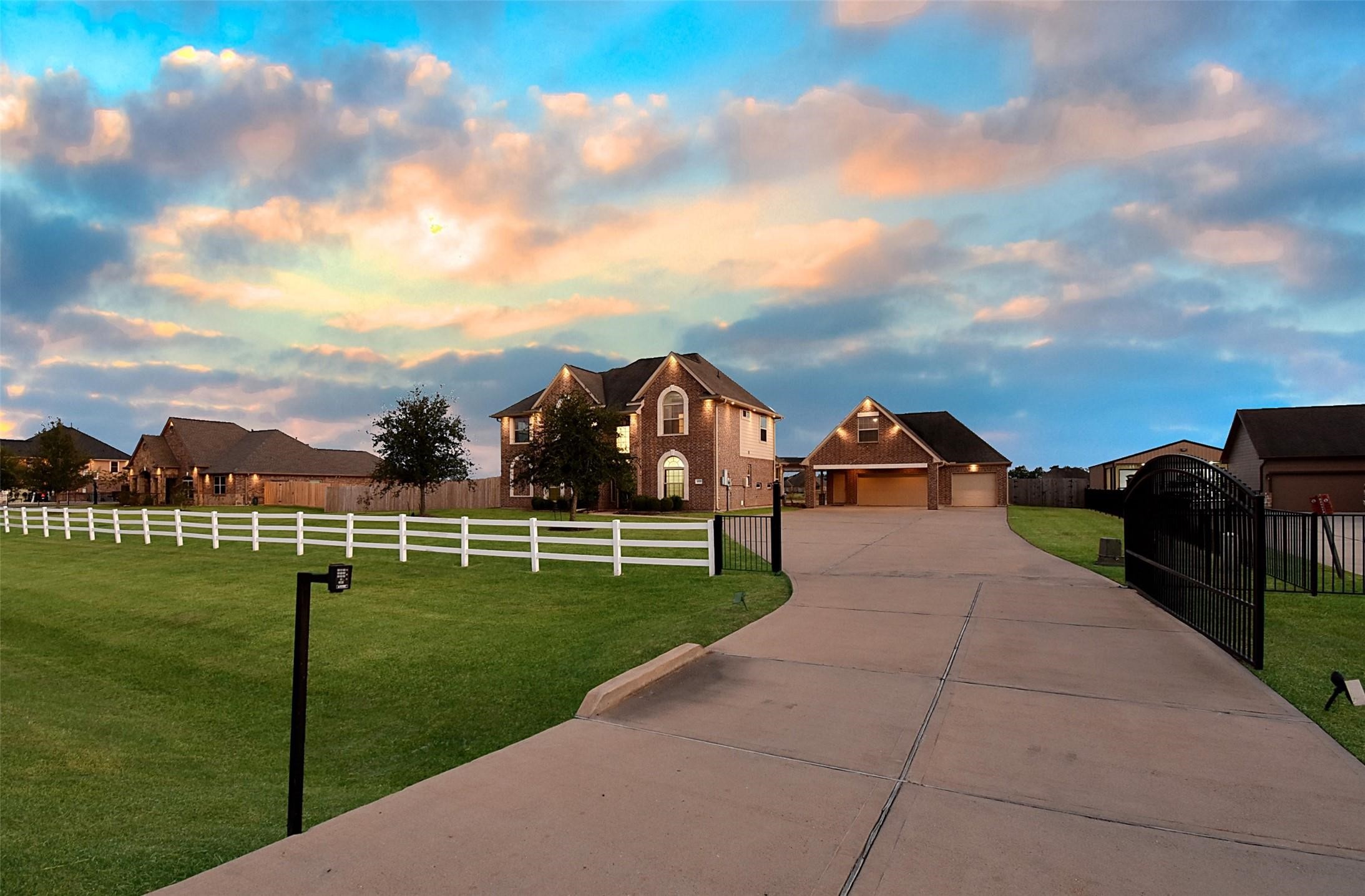 a view of a big house with a big yard and a fountain