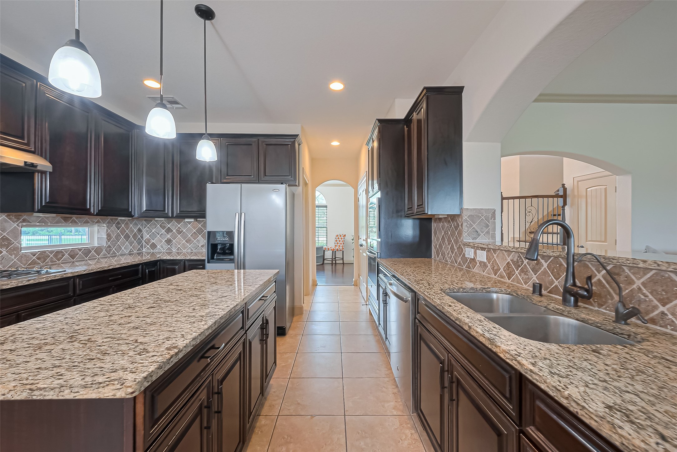 4810 Dubuque Parkway Rosharon, TX 77583 - Photo 14 of 45 a kitchen with granite countertop kitchen island a sink stainless steel appliances and a counter top space