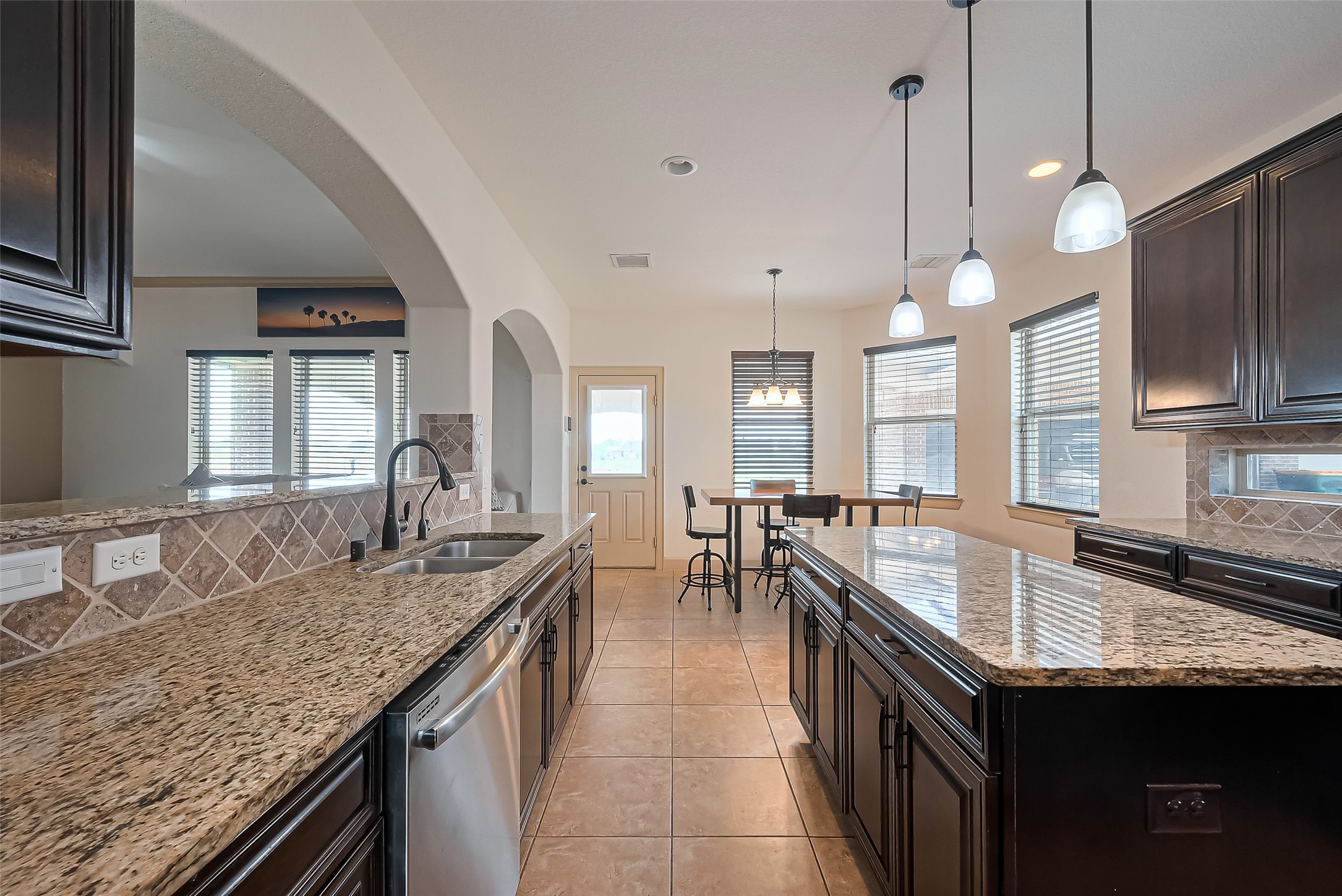 4810 Dubuque Parkway Rosharon, TX 77583 - Photo 16 of 45 a kitchen with granite countertop kitchen island a sink and a stove
