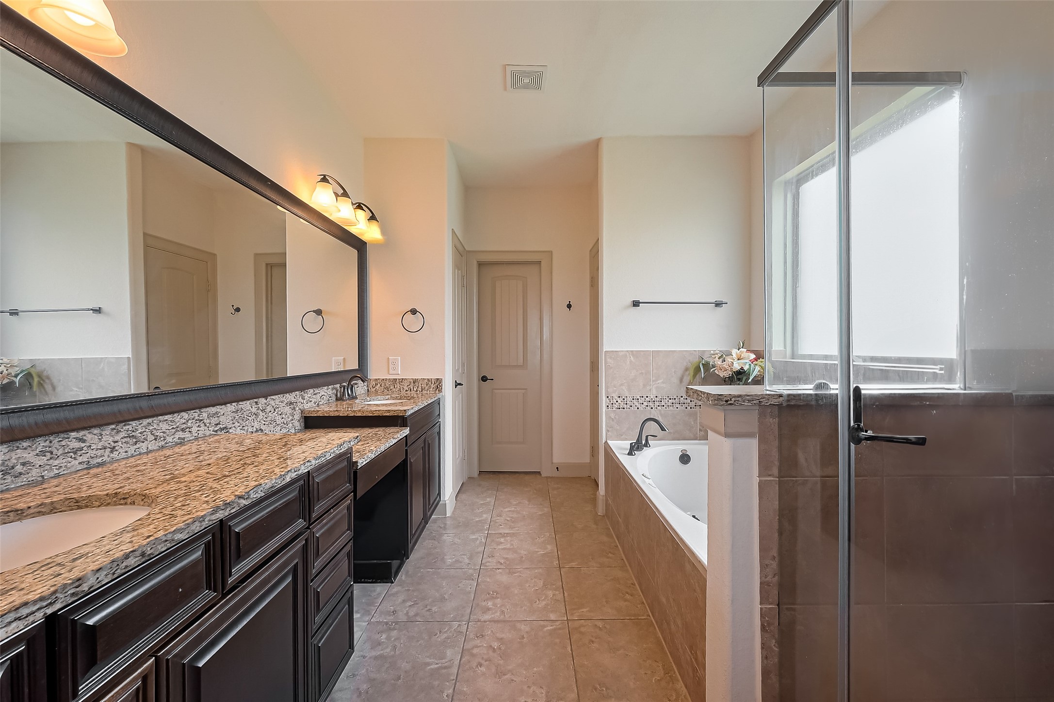 4810 Dubuque Parkway Rosharon, TX 77583 - Photo 19 of 45 a spacious bathroom with a granite countertop sink a large mirror and a bathtub
