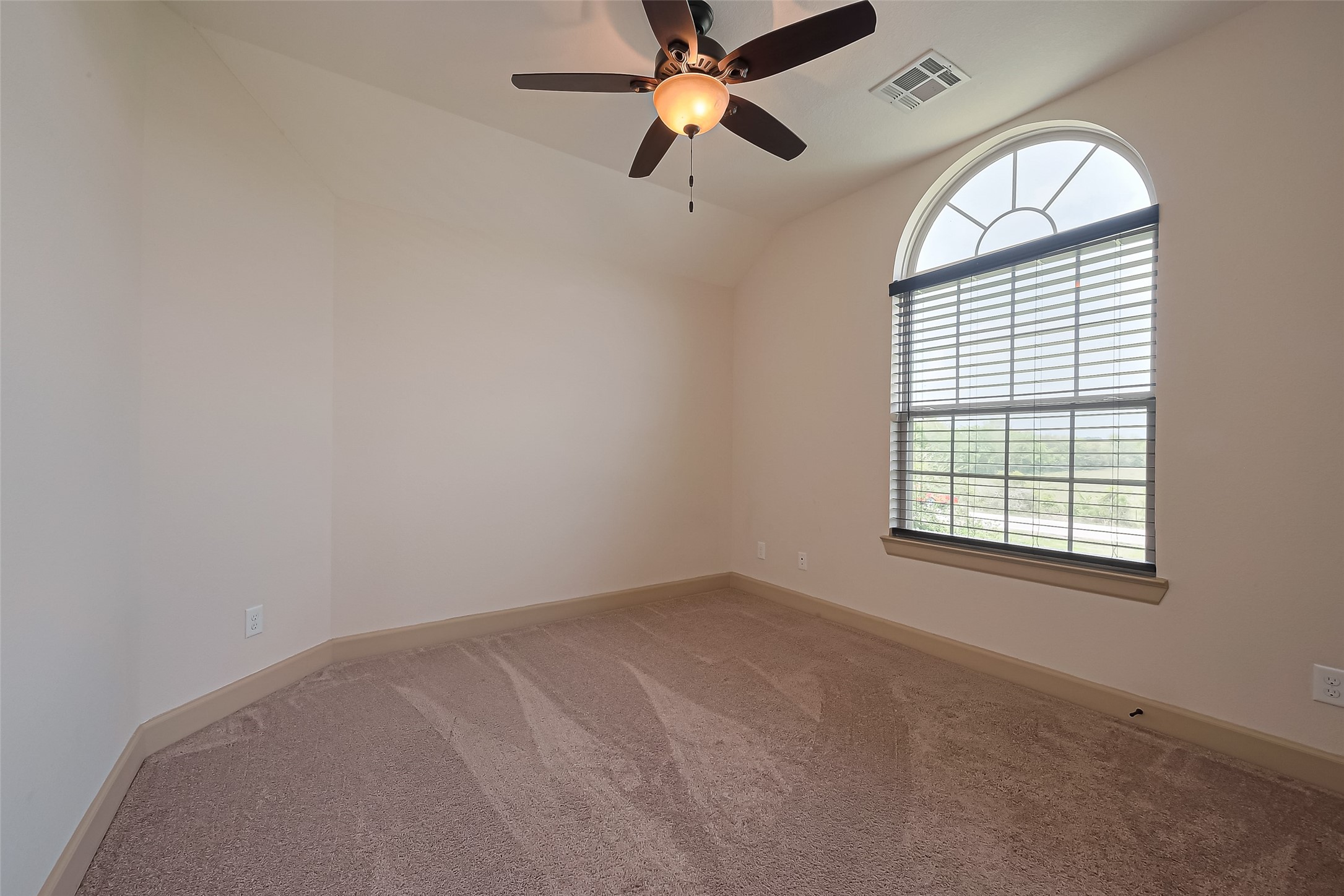 4810 Dubuque Parkway Rosharon, TX 77583 - Photo 30 of 45 an empty room with windows and fan