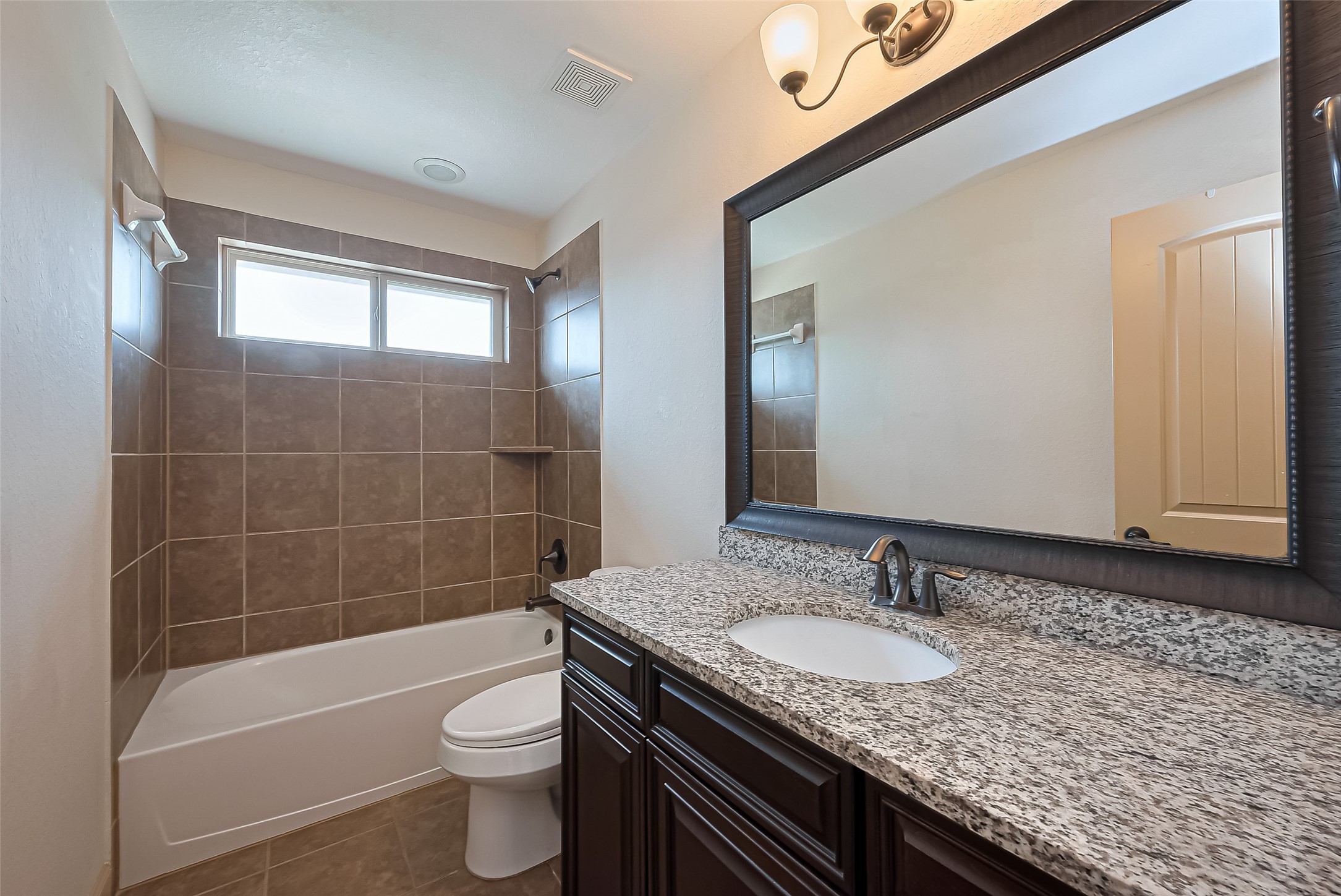 4810 Dubuque Parkway Rosharon, TX 77583 - Photo 31 of 45 a bathroom with a granite countertop sink toilet and shower