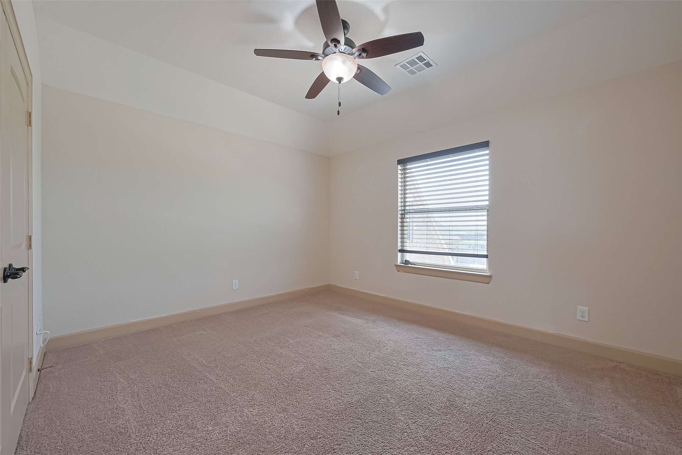 4810 Dubuque Parkway Rosharon, TX 77583 - Photo 32 of 45 an empty room with a window and a fan