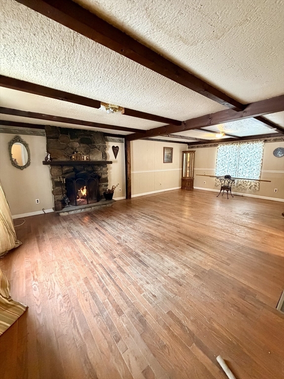 48 Broad Street Rehoboth, MA 02769 - Photo 2 of 19 an empty room with wooden floor and a fireplace
