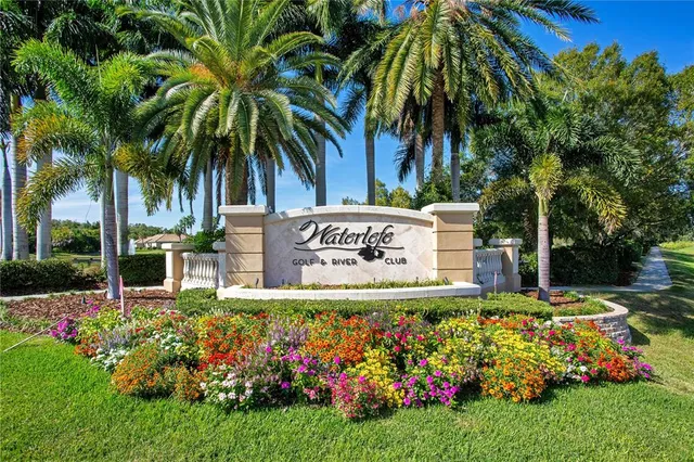 a sign that is sitting in front of flowers