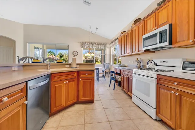 a kitchen with stainless steel appliances granite countertop a sink and cabinets
