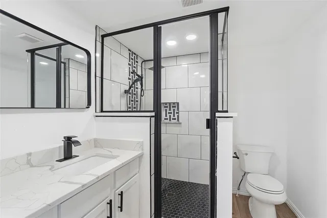 a bathroom with a sink toilet and shower