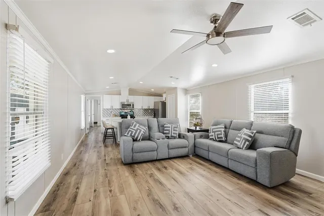 a living room with furniture and a wooden floor