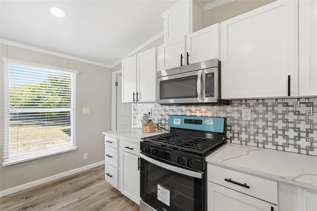 a kitchen with a stove and a microwave