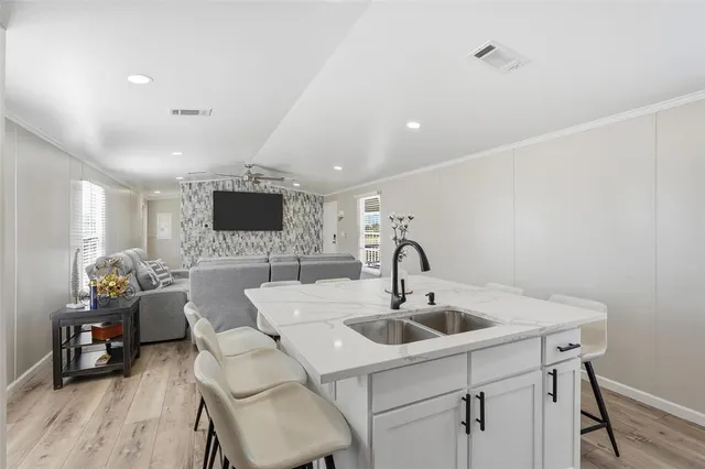 a kitchen with a sink cabinets and wooden floor