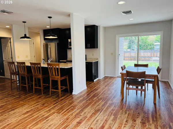 a view of a livingroom with furniture window and wooden floor