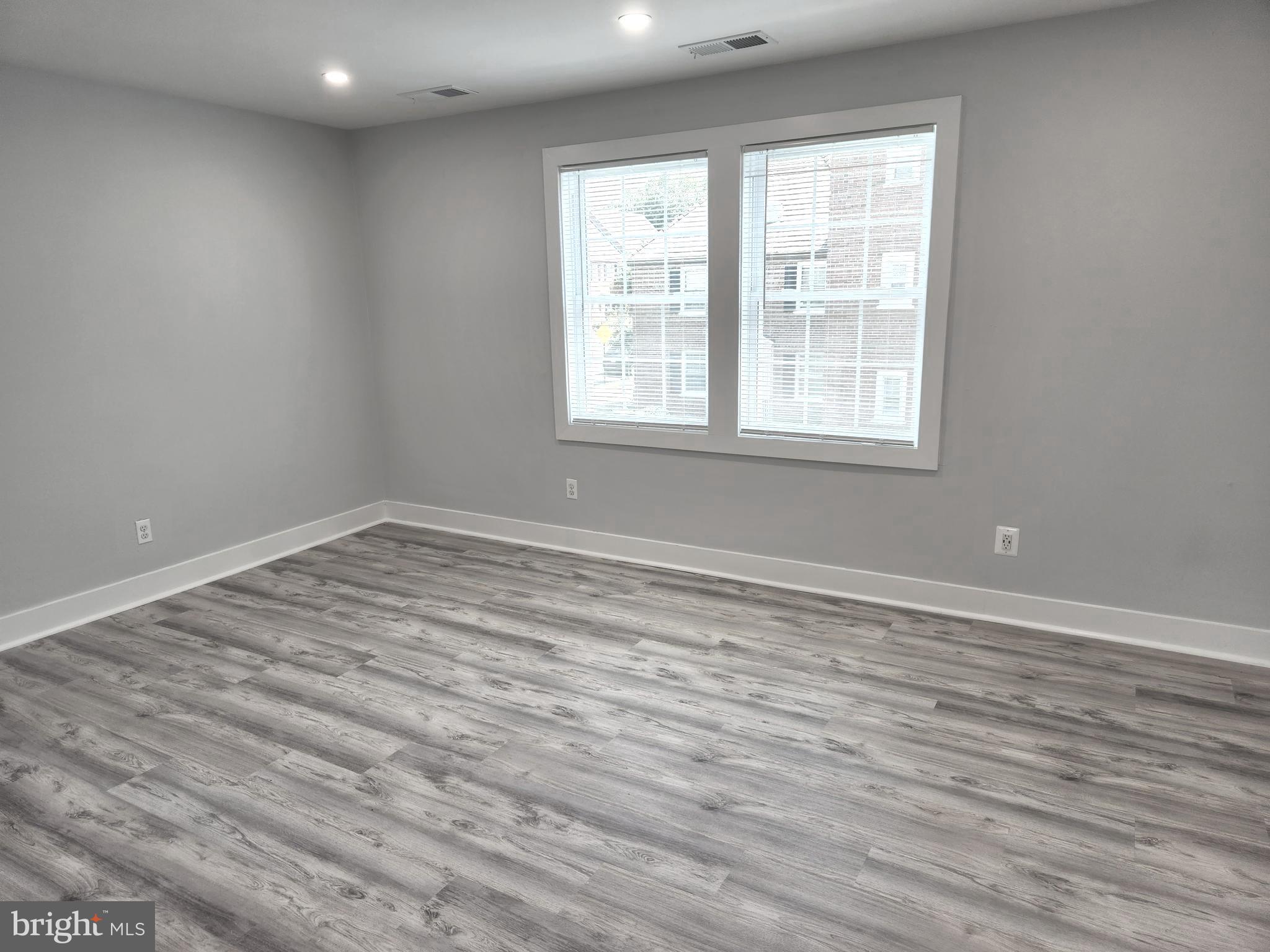 3809 V Street Southeast, Unit 202 Washington, DC 20020 - Photo 12 of 20 wooden floor in an empty room with a window