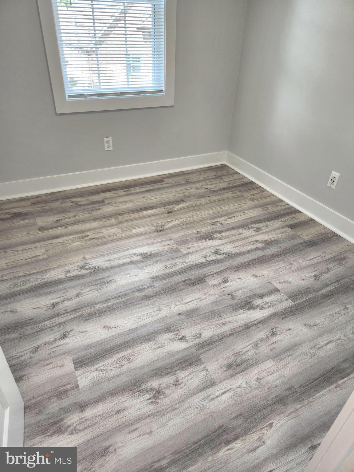 3809 V Street Southeast, Unit 202 Washington, DC 20020 - Photo 13 of 20 a view of empty room with window and wooden floor
