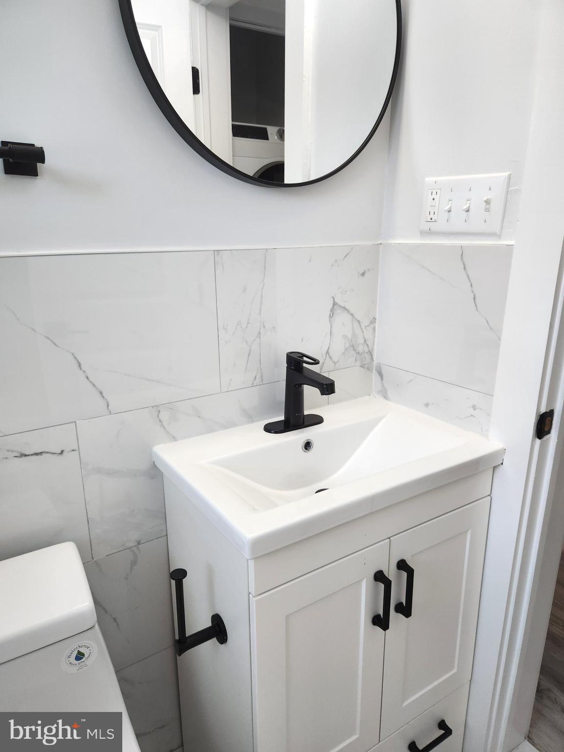3809 V Street Southeast, Unit 202 Washington, DC 20020 - Photo 18 of 20 a bathroom with a sink and mirror