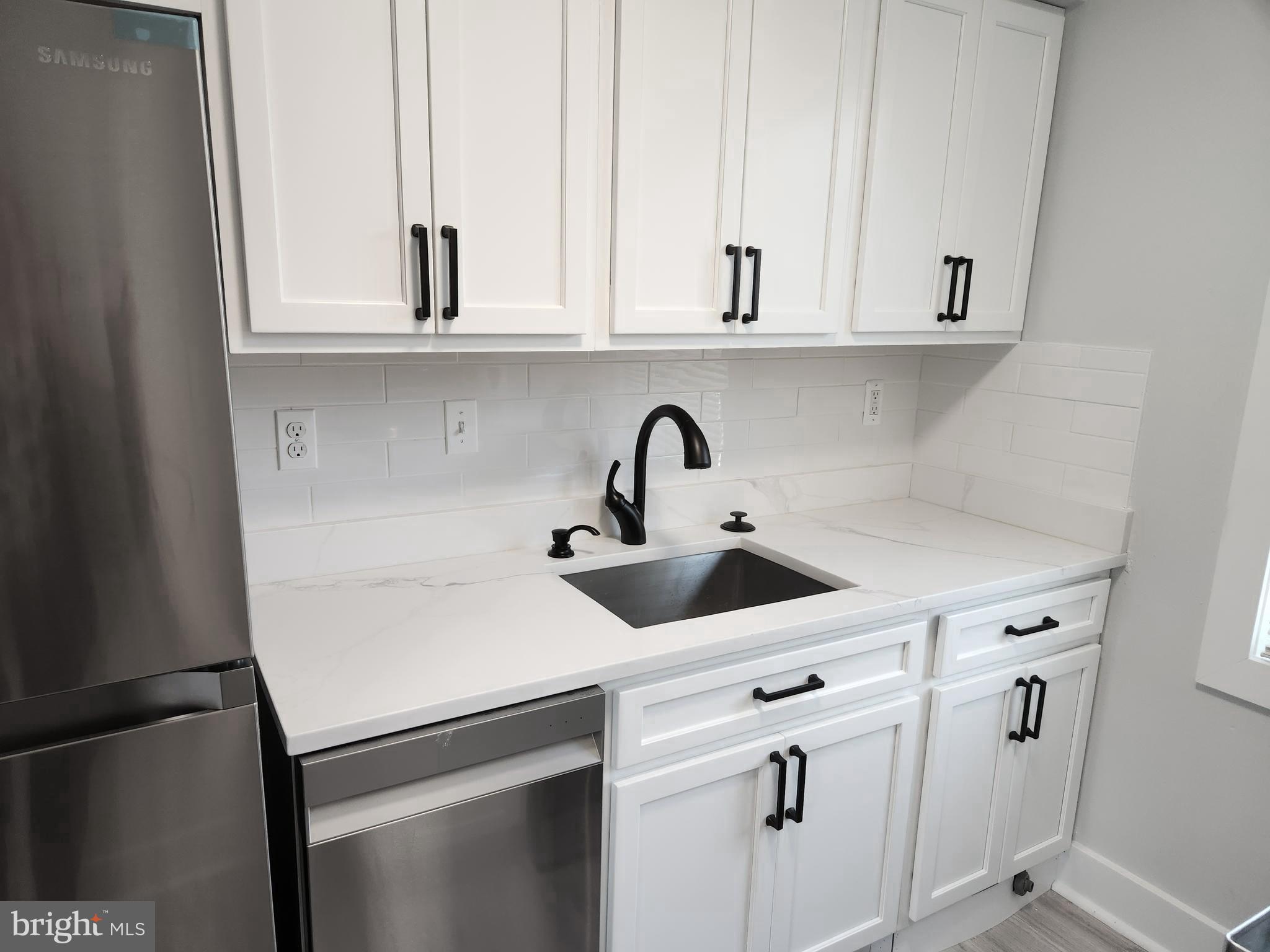3809 V Street Southeast, Unit 202 Washington, DC 20020 - Photo 4 of 20 a kitchen with white cabinets and sink