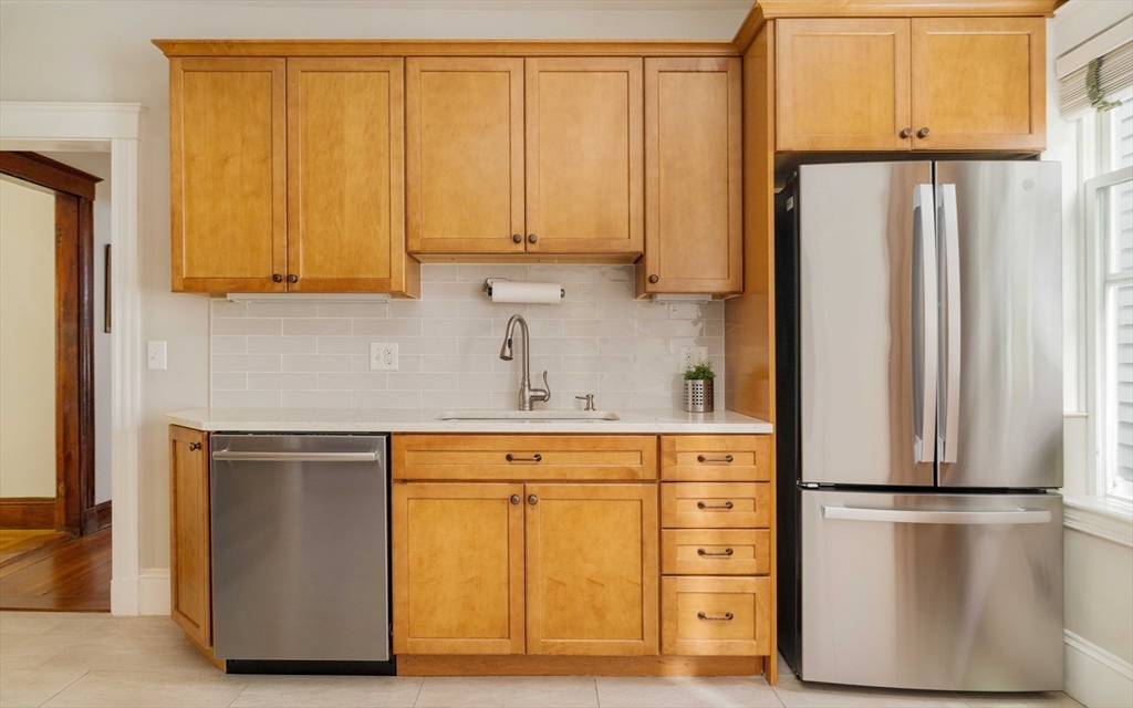 59 Pemberton Street, Unit 1 Cambridge, MA 02140 - Photo 12 of 30 a kitchen with a refrigerator a sink and cabinets