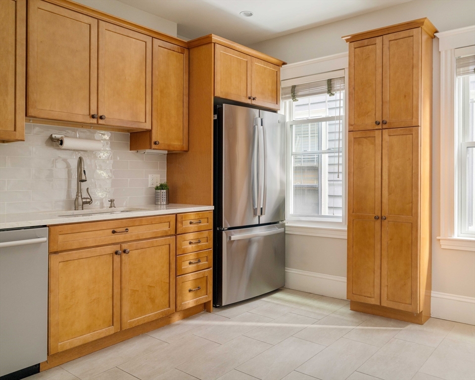59 Pemberton Street, Unit 1 Cambridge, MA 02140 - Photo 13 of 30 a kitchen with appliances a refrigerator and cabinets