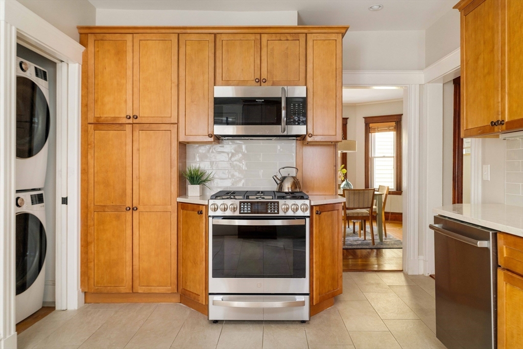 59 Pemberton Street, Unit 1 Cambridge, MA 02140 - Photo 14 of 30 a kitchen with stainless steel appliances granite countertop a stove a refrigerator and a microwave