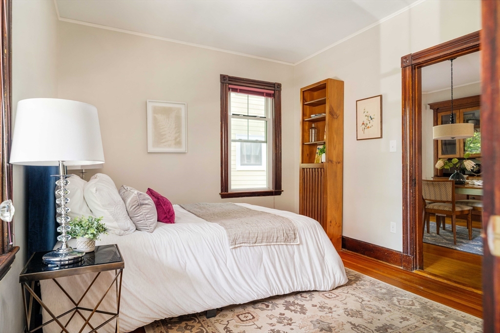 59 Pemberton Street, Unit 1 Cambridge, MA 02140 - Photo 25 of 30 a bedroom with a bed and a lamp on dresser