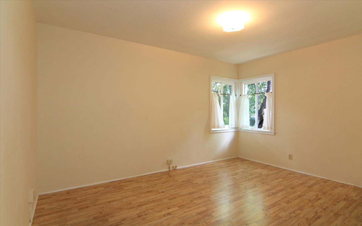 1251 Pacific Street Monterey, CA 93940 - Photo 11 of 25 a view of an empty room with wooden floor and a window