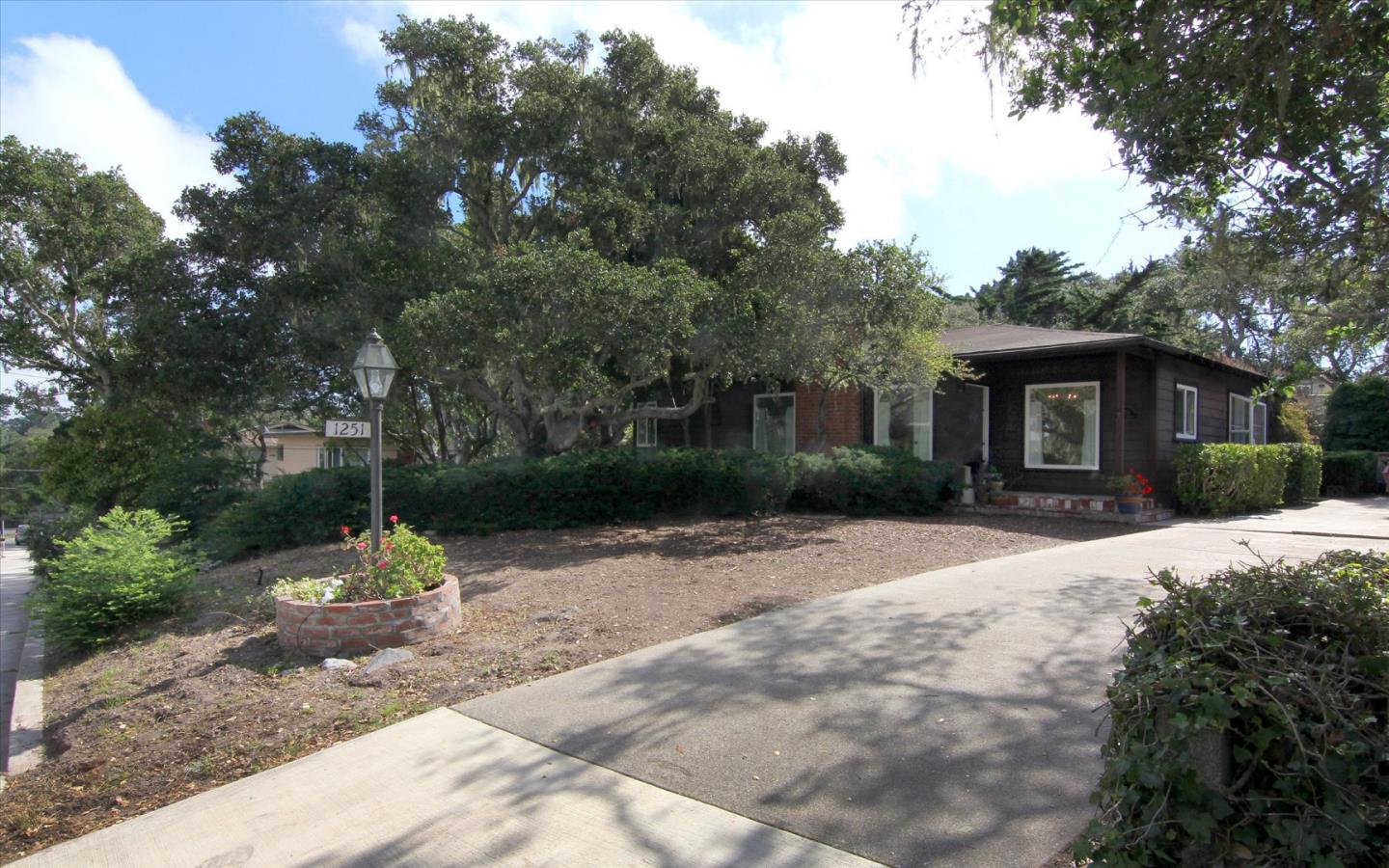 1251 Pacific Street Monterey, CA 93940 - Photo 2 of 25 a front view of a house with a yard