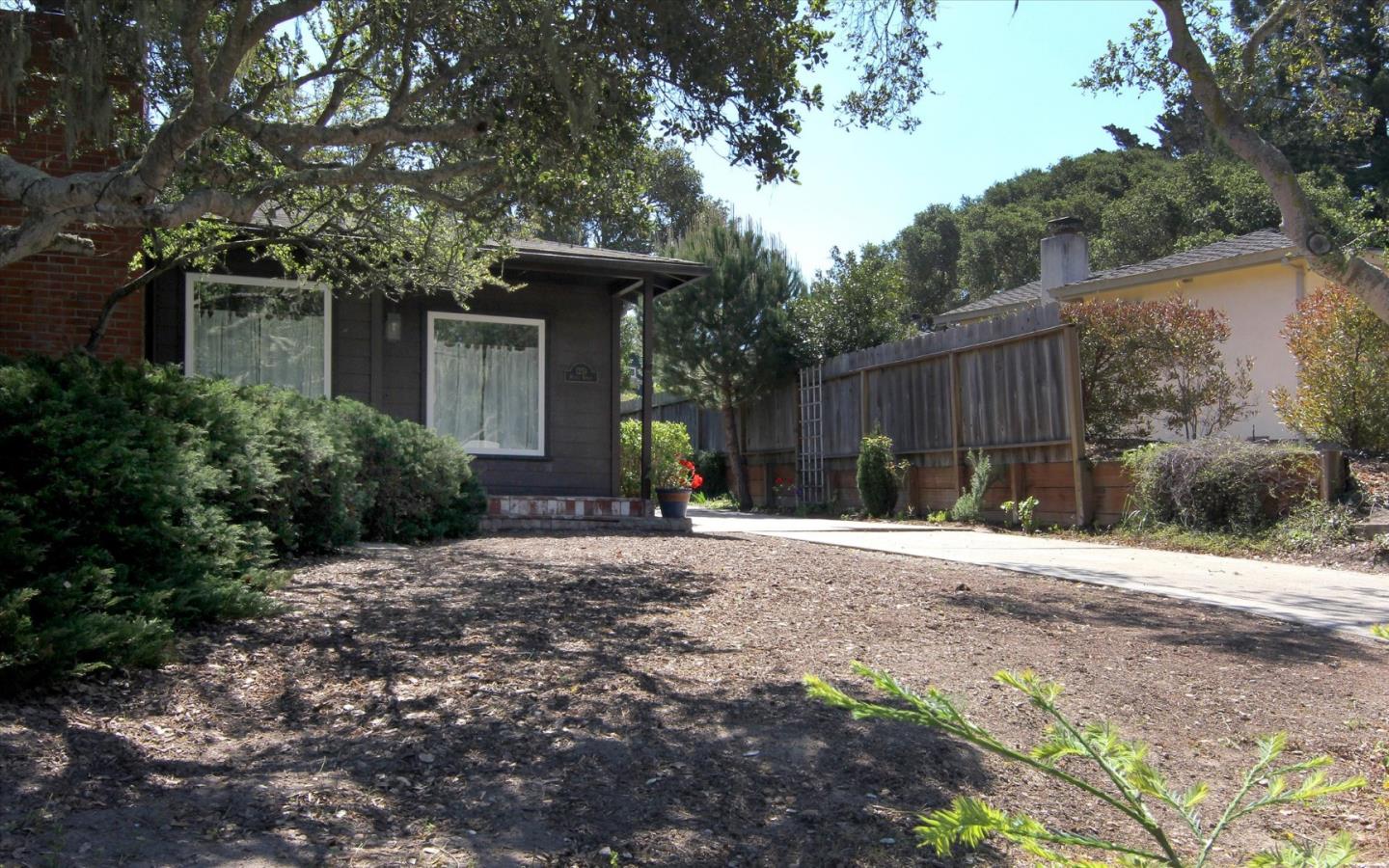 1251 Pacific Street Monterey, CA 93940 - Photo 24 of 25 a front view of a house with a yard and trees
