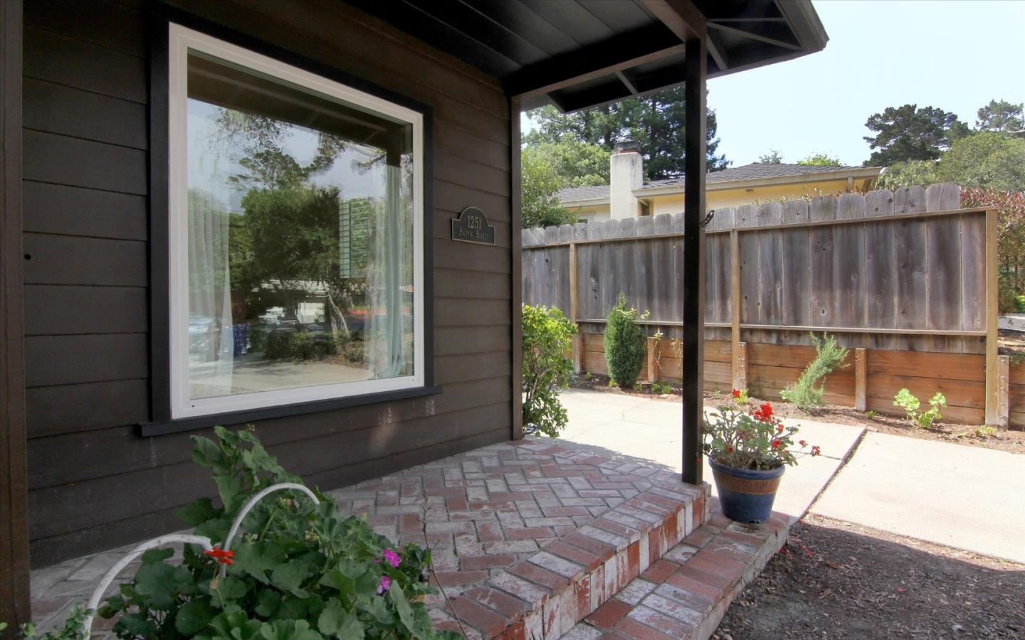 1251 Pacific Street Monterey, CA 93940 - Photo 3 of 25 a view of a porch with a floor to ceiling window and wooden fence