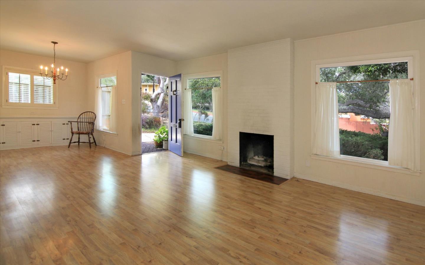 1251 Pacific Street Monterey, CA 93940 - Photo 5 of 25 an empty room with wooden floor and a fireplace