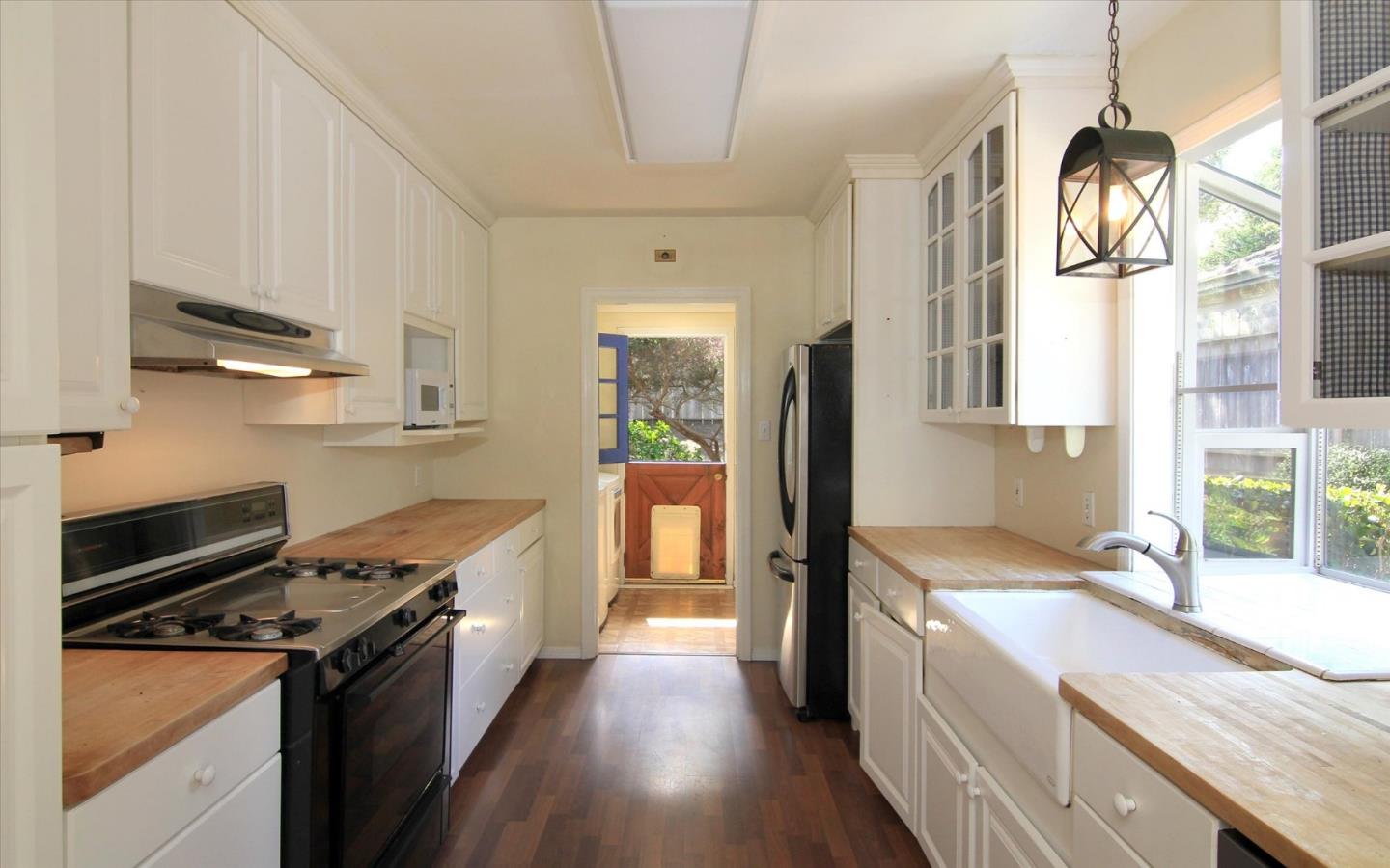 1251 Pacific Street Monterey, CA 93940 - Photo 8 of 25 a kitchen with stainless steel appliances granite countertop a sink stove and refrigerator