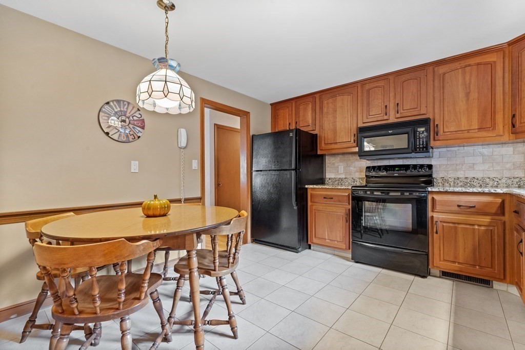 135 Rustic Road Walpole, MA 02032 - Photo 11 of 37 a kitchen with stainless steel appliances granite countertop a kitchen island hardwood floor and a view of living room