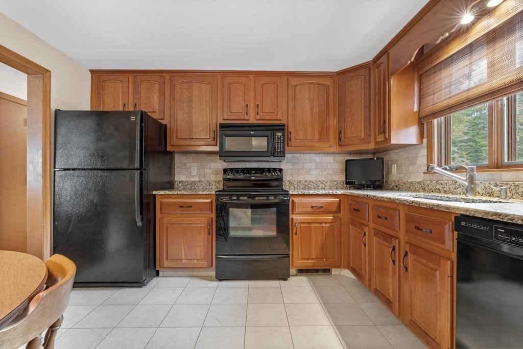 135 Rustic Road Walpole, MA 02032 - Photo 12 of 37 a kitchen with granite countertop a refrigerator stove top oven and sink