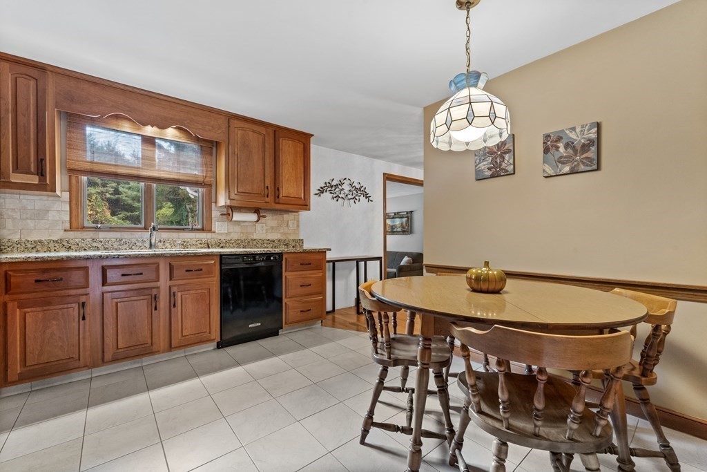 135 Rustic Road Walpole, MA 02032 - Photo 14 of 37 a view of a table and chairs in a kitchen