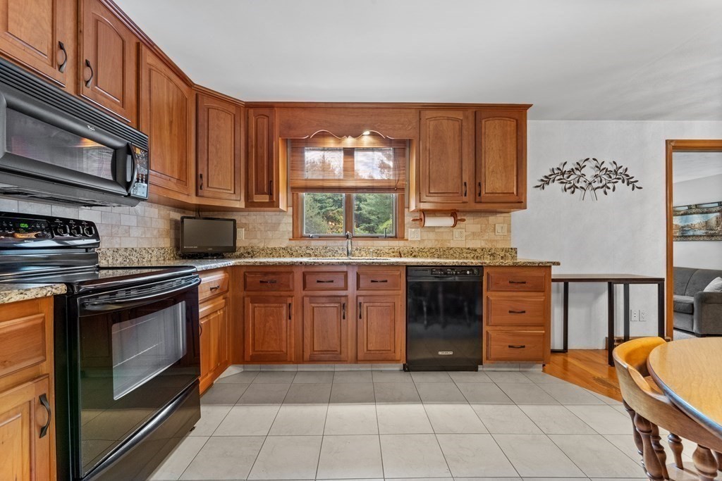 135 Rustic Road Walpole, MA 02032 - Photo 15 of 37 a kitchen with stainless steel appliances granite countertop a stove and cabinets