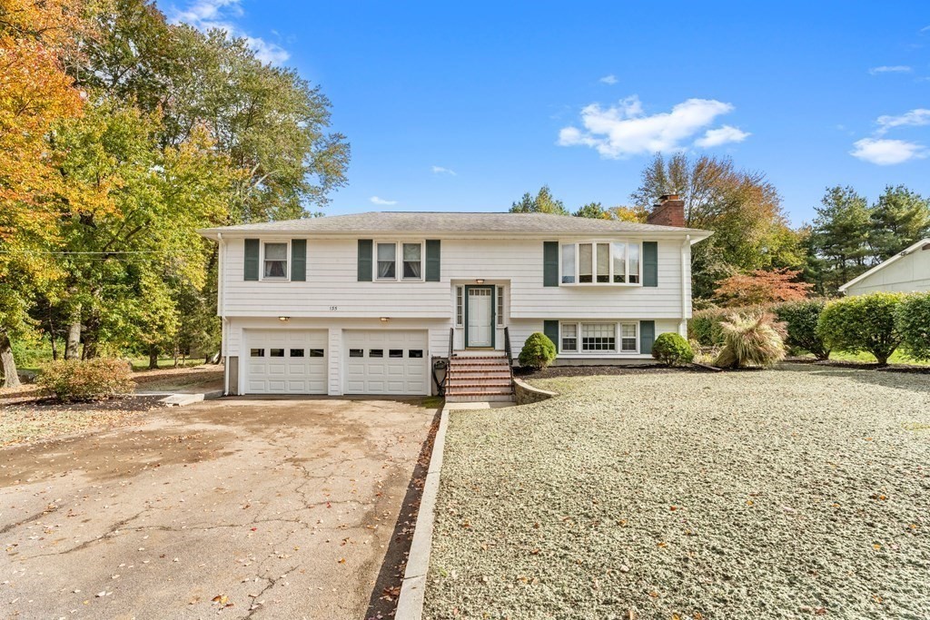 135 Rustic Road Walpole, MA 02032 - Photo 2 of 37 a white house with a large tree in front of it