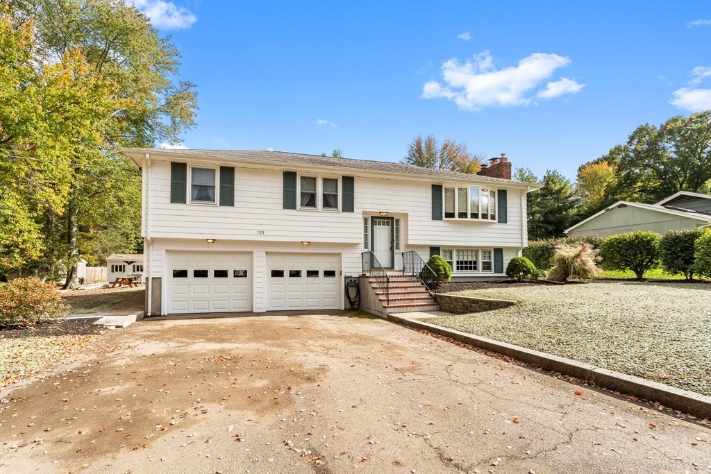 135 Rustic Road Walpole, MA 02032 - Photo 30 of 37 a blue sign that is sitting on the side of a road