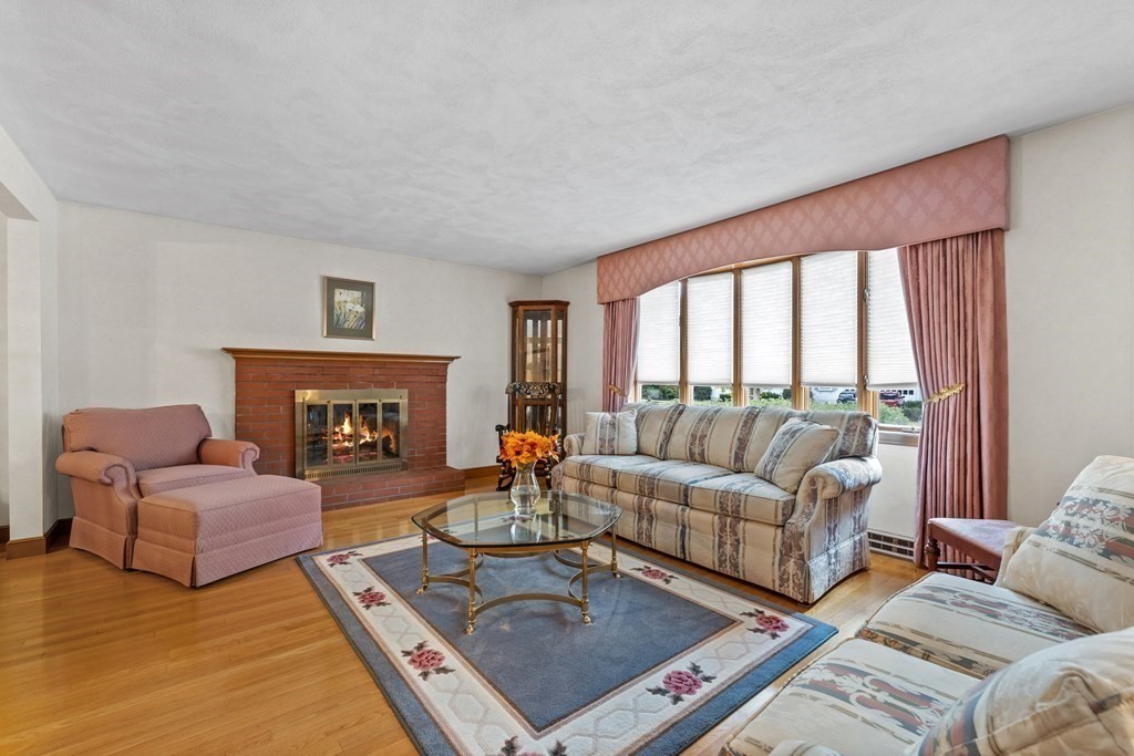 135 Rustic Road Walpole, MA 02032 - Photo 6 of 37 a living room with furniture and a fireplace
