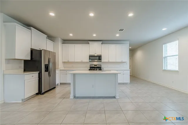 a kitchen with a sink stainless steel appliances and cabinets