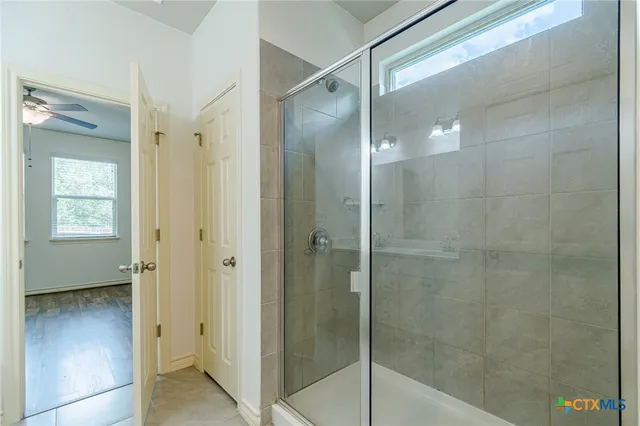 a bathroom with a glass shower door