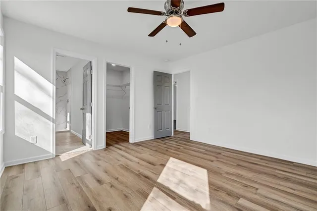 a view of a room with wooden floor and white walls