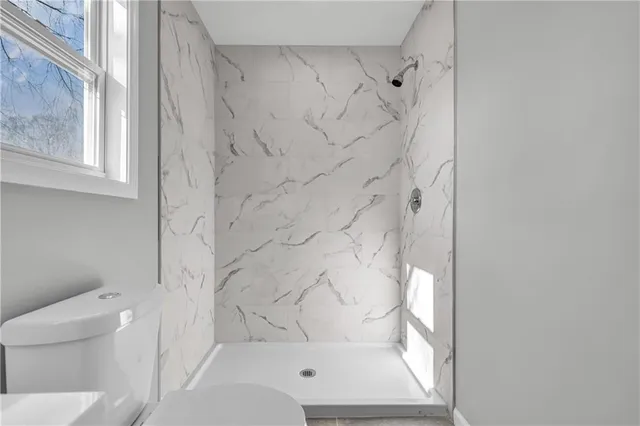 a bathroom with a bathtub and a toilet