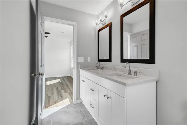 a bathroom with 2 sink and a mirror