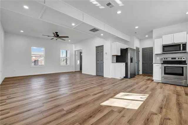 a view of a kitchen with sink and wooden floor