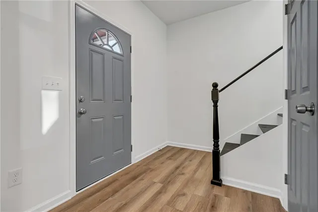 a view of front door with wooden floor