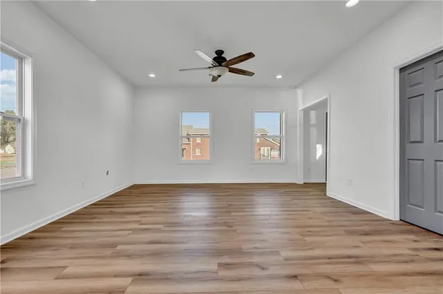 wooden floor in an empty room with a window