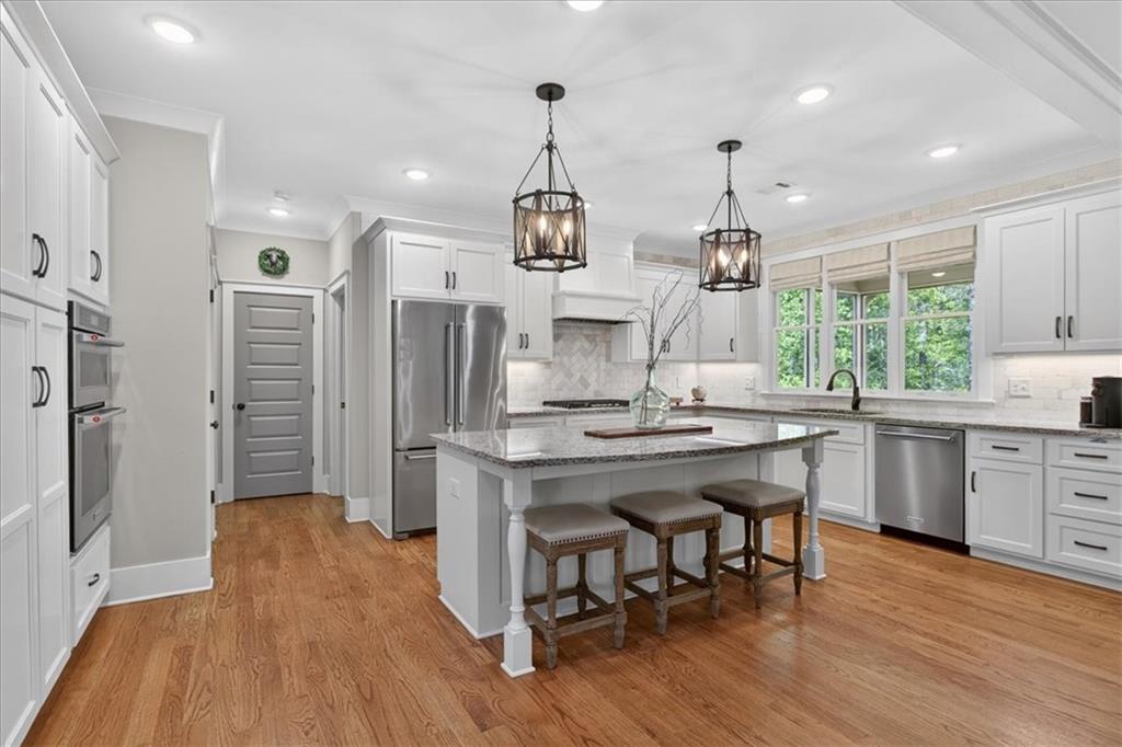122 Brookfield Court White, GA 30184 - Photo 13 of 63 a kitchen with stainless steel appliances granite countertop a refrigerator a sink dishwasher a stove and white cabinets with wooden floor