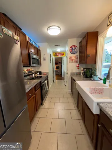 a kitchen with stainless steel appliances a stove sink and microwave