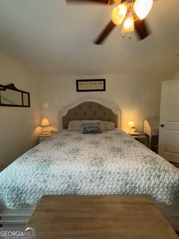 a bedroom with a bed and a chandelier