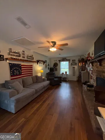 a living room with furniture gym equipment and a window