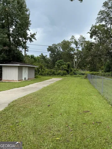 a view of outdoor space with deck and yard