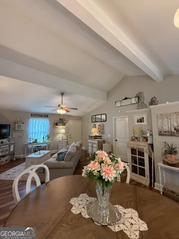 a living room with furniture fireplace and kitchen view